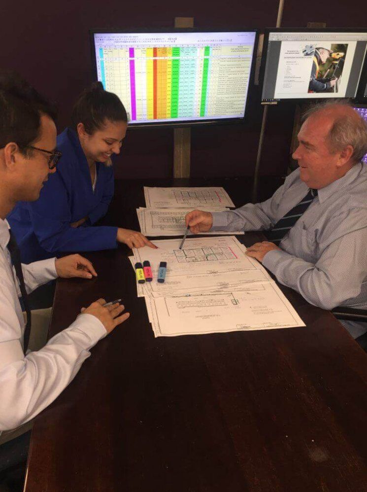 Super Valuations valuers working through plans and market data at the office